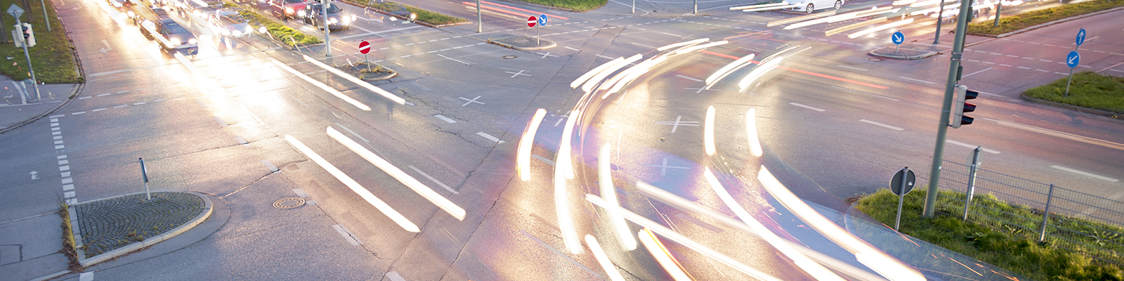 Street intersection with lines made from light that signify car driving marks.