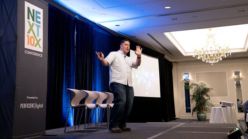 Yext's Duane Forrester Speaking on stage at Next10x Conference in Boston in 2019