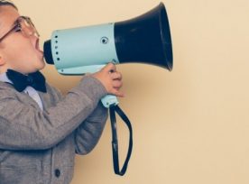 Young Nerd Boy Yells Into Megaphone