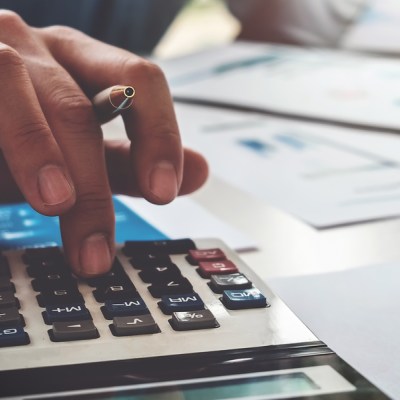 Business Accounting Concept, Business Man Using Calculator With Computer Laptop, Budget And Loan Paper In Office.