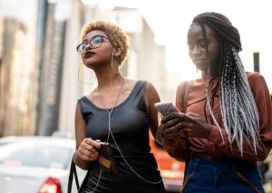 Two women waiting for a rideshare pick up