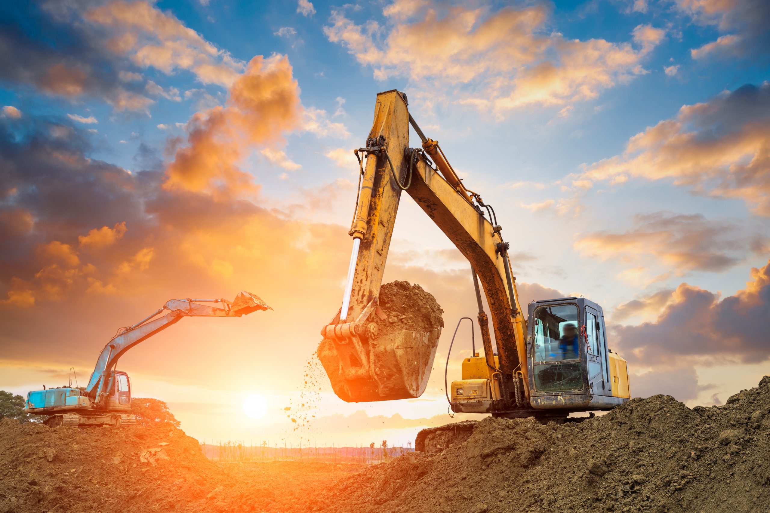 Excavator In Construction Site On Sunset Sky