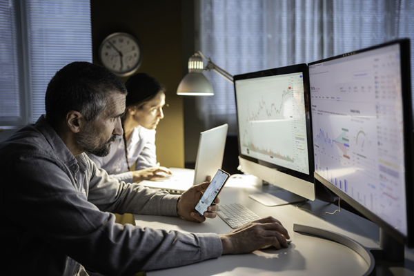 People using technology to check on stocks and financial information.