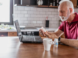 Man reading prescription bottle label