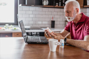 Man reading prescription bottle label