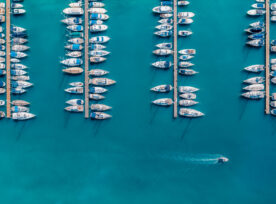 Aerial View Of Luxure Yachts And Motorboats Moored In A Port With Clear Blue Water In Summer. Top View From Drone Of Sailboats And Various Speed Boats In Dock. Pula, Croatia