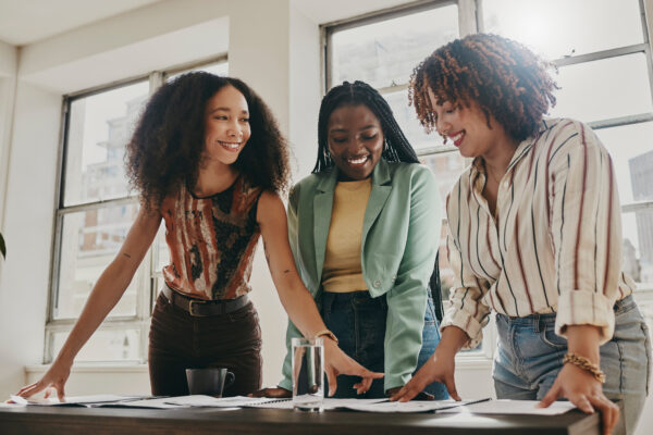 Teamwork, Collaboration And Planning Black Women With Documents, Paperwork Or Design Strategy In Office. Business Startup, Gender Equality And Marketing Ideas Of Diversity People In Workspace Meeting