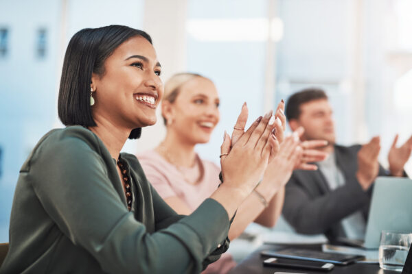 Shot Of A Group Of Businesspeople Clapping During A Meeting In A Modern Office