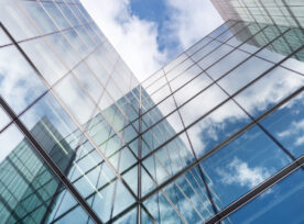 Looking Up A Reflections On Glass Covered Corporate Building