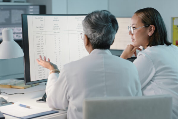Science, Hospital And Women On Computer For Research, Medical Report And Data Analytics In Laboratory. Healthcare, Teamwork And Female Scientist In Discussion For Analysis, Results And Biotechnology