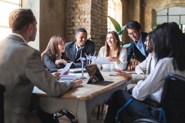 Group Of Multiethnic Businesspeople Discussing About Financial Strategy, Renewable Power, Sustainable Innovation Project And Environmental Economical Issues Business, Sustainability Interracial Lifestyle Concept