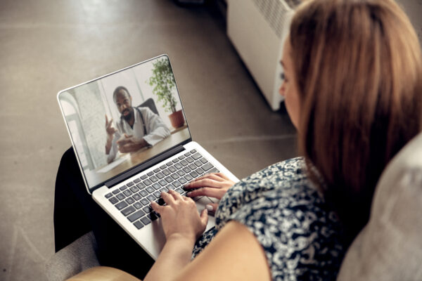 Close Up Of Young Woman Getting Online Medical Help And Advice During Videocall With Doctor Checking Symtoms Aand Explaining The Drug's Reciepes