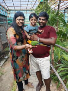 Ramya and her family holding a bird