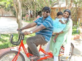 Ramya and her family riding a bike