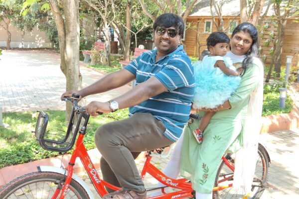 Ramya and her family riding a bike