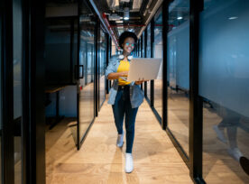 Happy It Technician Working At The Office Using Her Laptop