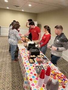 Perficient employees serving catered dinner to Extra Special People organization
