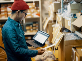 Mid Adult Male Retail Shop Staff Checking Or Looking For Inventory In A Storage Room