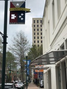 Downtown Lafayette sign with LUS Fiber sign in back