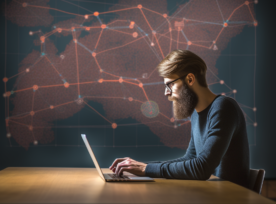 Man Typing On Laptop At Desk