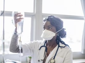 Young Woman Wearing Face Mask Checking Iv Drip