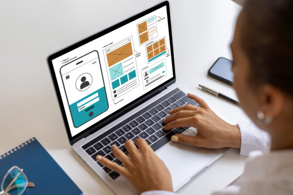 Testing wireframes on laptop for conducting UAT on your website