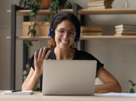 Smiling Woman In Headphones Greeting Talking On Video Call