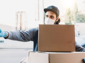 Delivery Man Is Ringing The Bell To Deliver Two Cardboard Boxes