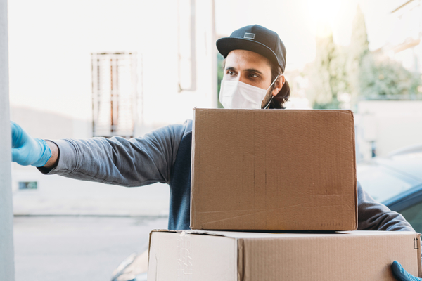 Delivery Man Is Ringing The Bell To Deliver Two Cardboard Boxes