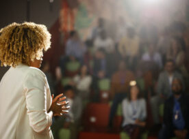 Woman Presenting At Conference