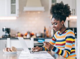 Smiling Afro Woman Shopping Online At Home