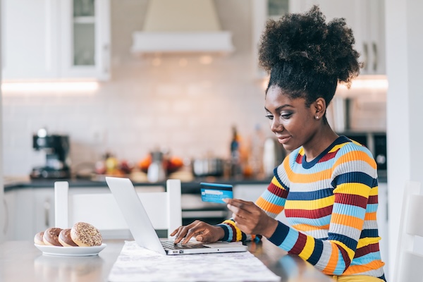 Smiling Afro Woman Shopping Online At Home