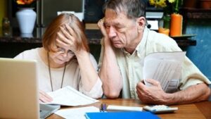 Worried Couple Reviewing Paperwork