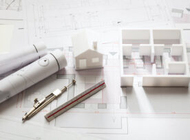 Construction Concept. Residential Building Drawings And Architectural Model,