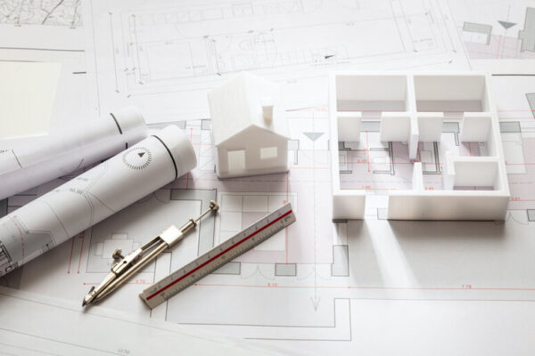 Construction Concept. Residential Building Drawings And Architectural Model,