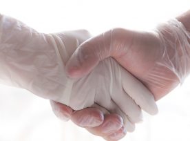 Coronavirus Two People Shaking Hands With Gloves To Avoid Contagion