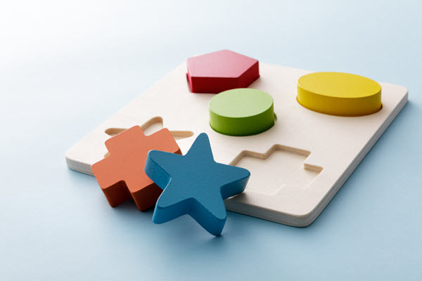 Explicit vs Implicit, illustrated by a children’s shape sorting toy.