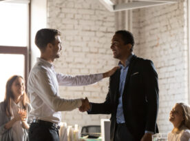 Caucasian Boss Congratulates African Employee With Promotion