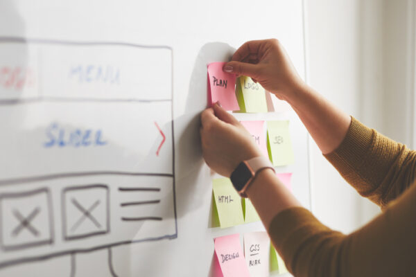 Web-Designer-Planning-Product-Development-On-Whiteboard