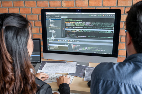 Young developers working together, programming.