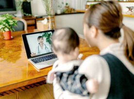 Mother With Her Baby Video Calling Doctor From Home