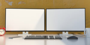 Blank Screens On A Computer Desktop Monitors, Yellow Color Wall Background. 3d Illustration
