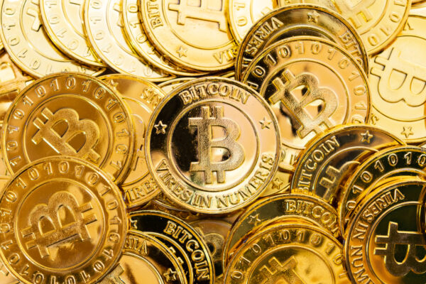 Bitcoin Cryptocurrency Background. A Bunch Of Golden Bitcoin, Digital Currency