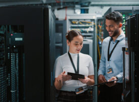 A man and woman working together in a data center