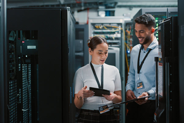 A man and woman working together in a data center