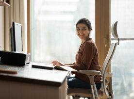 Happy Biracial Businesswoman Freelancer Sit By Computer At Comfy Workplace