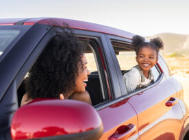 Mother And Black Daughter Peeping Outside Car