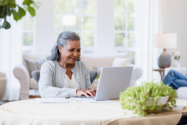 Mother Sits At Her Computer Answering Emails