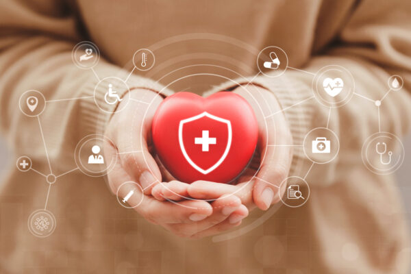 Women Hands Holding Red Hearts With Virtual Medical Network Connection Icons, Health Care, Life Insurance Business Concept, And Rising Growth In Hospital And Health Insurance Business. World Health Day