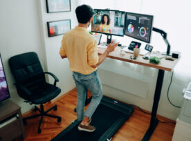 Man At Standing Desk Home Office Talking On Business Video Call